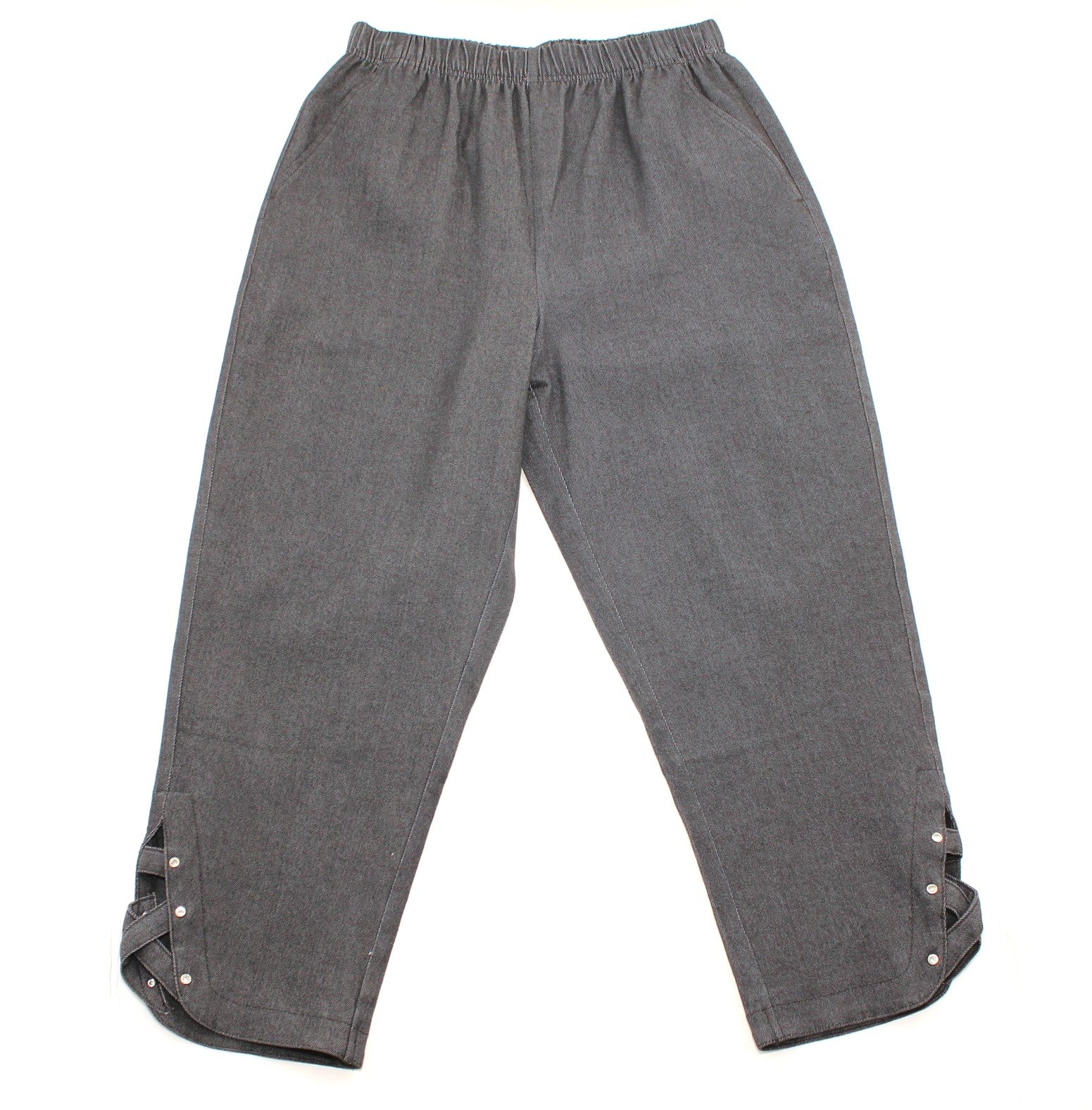 A pair of dark gray relaxed-fit pants with an elastic waistband and decorative lace-up ankle cuffs with silver buttons, shown flat on a white background.