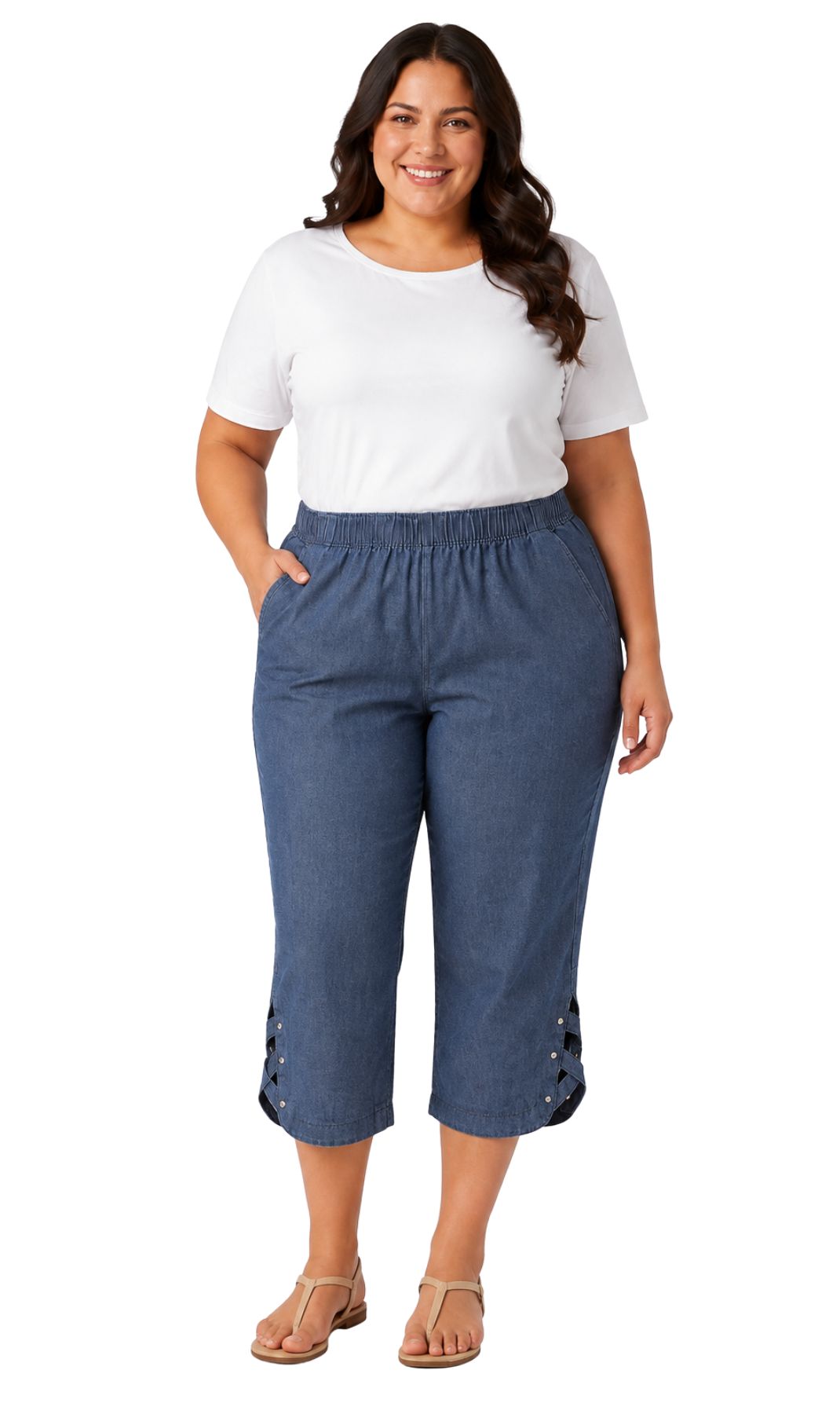 A women shown wearing blue cropped pants with lace-up detailing at the lower hems, paired with a white top and tan sandals, against a plain white background.