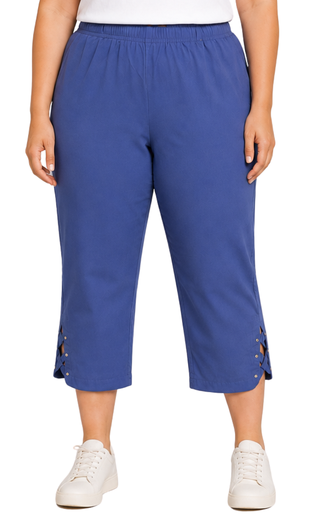 A person wearing blue cropped pants with side lace-up details and white sneakers, shown from the waist down against a plain white background.