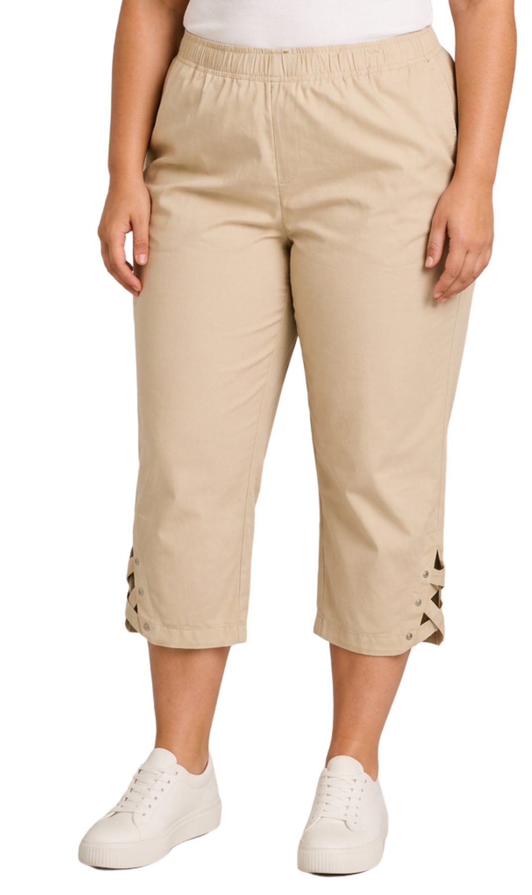 A person wearing beige cropped pants with lace-up detailing at the cuffs, paired with white sneakers, shown against a plain white background.