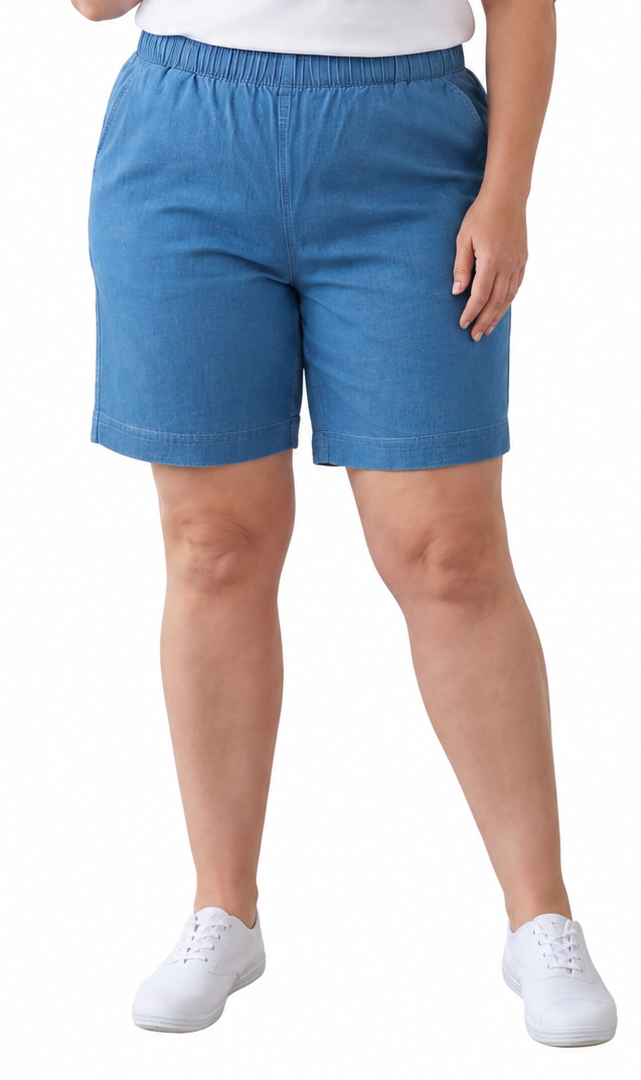 A woman modeling a white short-sleeve t-shirt and blue shorts against a plain white background.