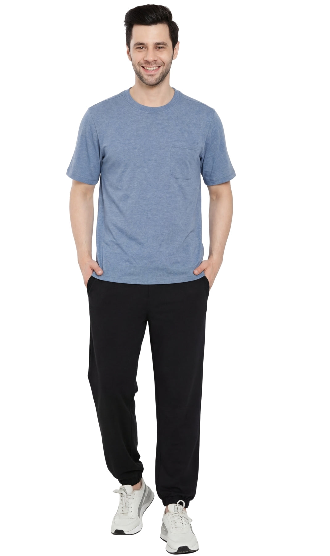 Man wearing a blue t-shirt and black pants on a white background